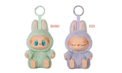 Two plush keychains, one green and one gray, with 'OUQU' and 'ZIZI' labels on a white background.